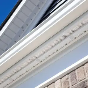 Close-up of Bear Light Track installed along the edge of a building, showcasing its sleek design for Govee permanent lights against a clear blue sky.